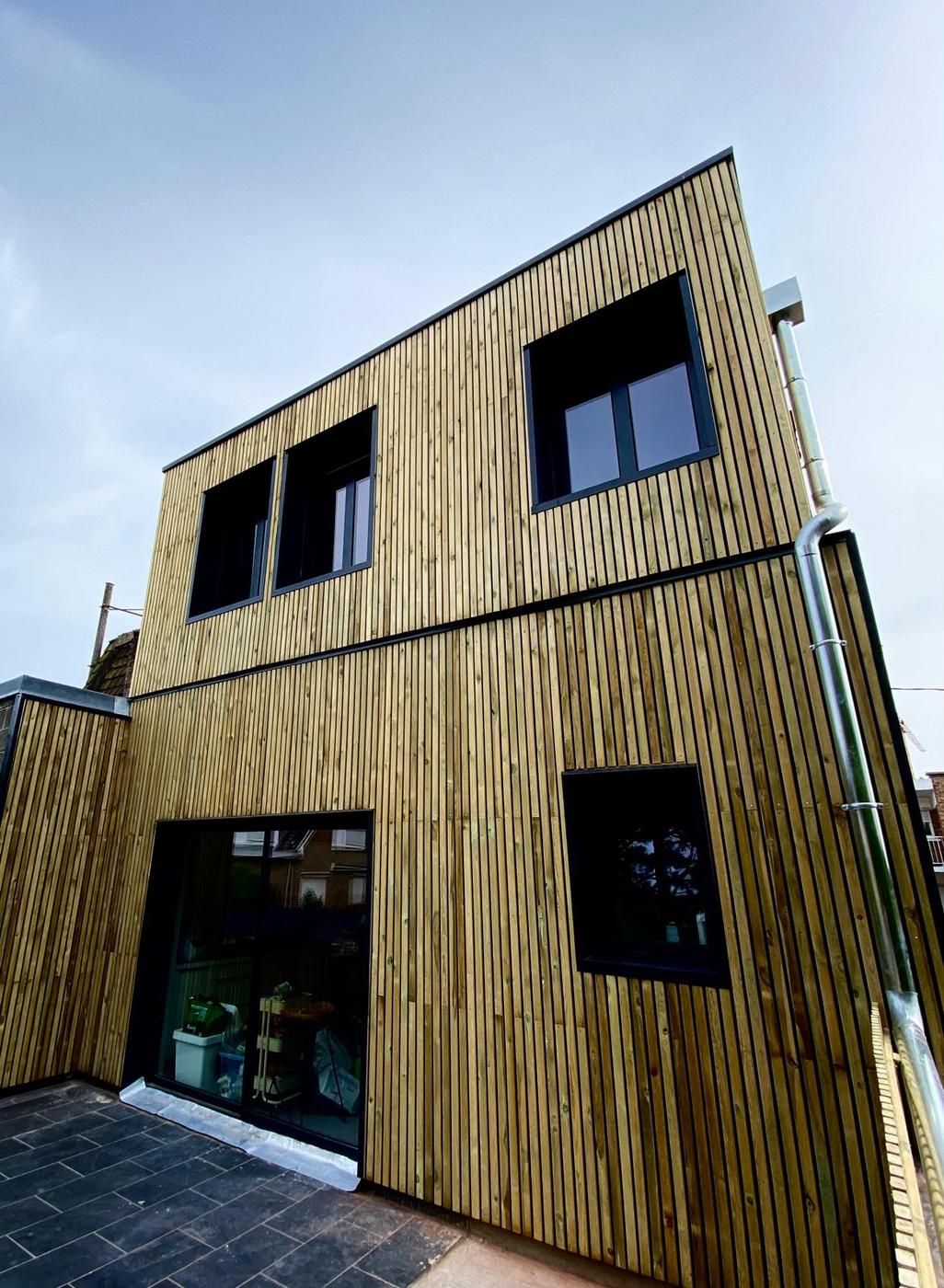 House with timber cladding and aluminium frames